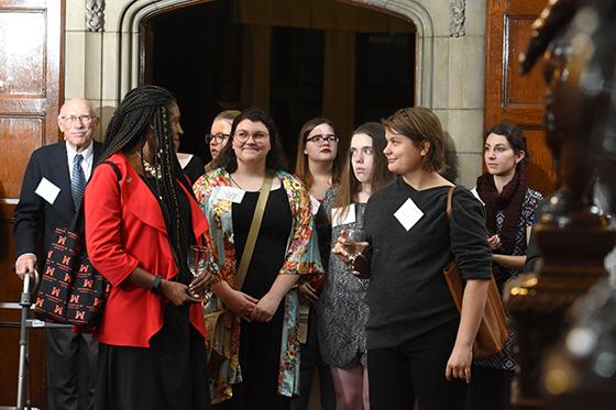 Photo of a group of people leaving a Chatham event, smiling and talking